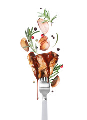 Hot fried beef steak on a fork with rosemary and garlic close up isolated on a white background