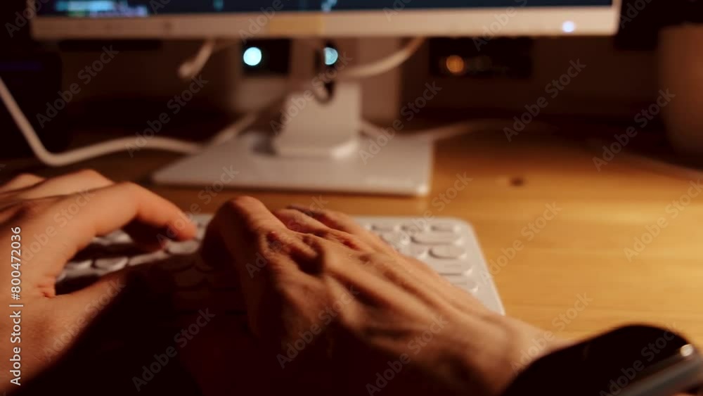Canvas Prints a young man programmer coding on a laptop in the dark with a view of the lights of the night city, c