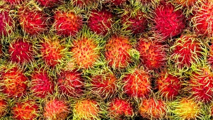 Fruit backdrop of vibrant rambutans, displaying their unique, tropical origin, making this image perfect for promoting exotic fruits in culinary and health focused markets. Healthy food