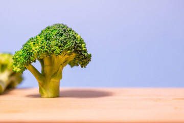freshly cut broccoli on a wooden cutting board