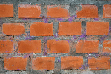 Red bricks in concrete wall with as background front view close up horizontal view