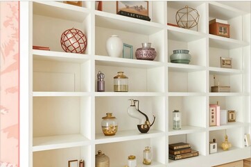 Shelves in the interior - snowy white, reliable, storing books, photos, and souvenirs, creating coziness and inspiration.