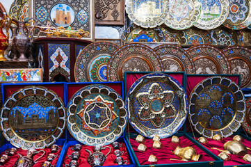 traditional Uzbek handmade metal and wooden plates hand-painted in a souvenir shop of Uzbekistan in Tashkent