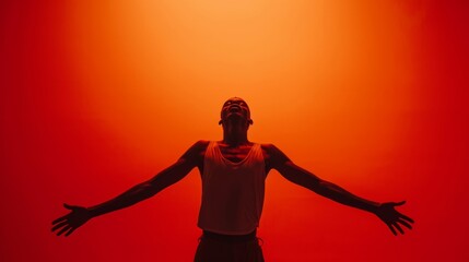 Man with open arms embracing light in a vibrant red ambiance.