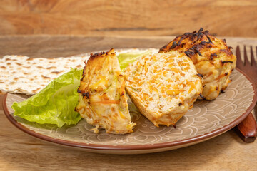 Chicken Vegetables Cutlets served with lettuce leaf, wooden cutlery, matzah piece on ceramic plate for Jewish holiday Pesach.