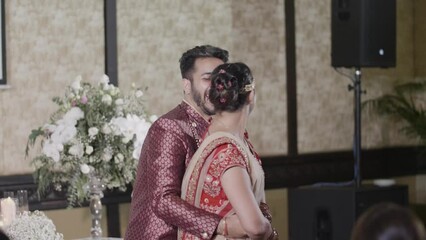 Indian Bride And Groom Dancing Happily At Hindu Wedding Reception. medium shot, slow motion - Powered by Adobe
