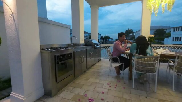 Couple On A Romantic Dinner Date At House's Pavilion By The Waterfront In Lagos De Batan, Samborondon, Ecuador. drone FPV