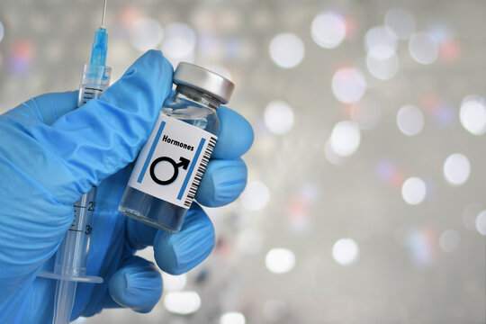Blue gloved hand holding a vial with male symbol, hormones injections, concept steroids