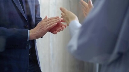 Business people clapping and showing recognition and approval, celebrating their teamwork and corporate achievement at a conference or seminar event