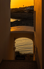 Corner in Biniancolla cove, among its white houses, on the island of Menorca. The golden tones are from the sunset. Spain