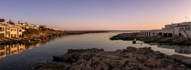 Panoramic photograph of the Biniancolla cove on the island of Menorca, offering a picturesque...