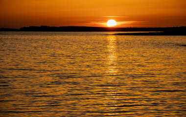 Spectacular sunset from Biniancolla cove, on the island of Menorca, Spain