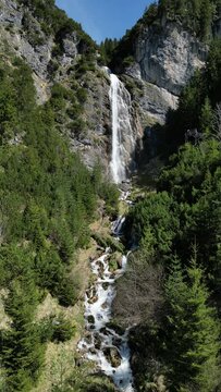 View to the dalfazer Waterfall with forest landscape and the Achensee as a close neighbor