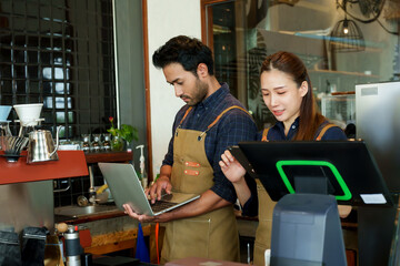 Asian couple runs cafe bakery together, man holding laptop computer, woman holding laptop,...