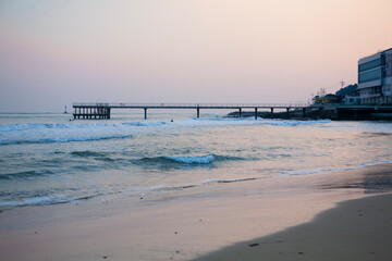 View of the bridge on the beach  in the dusk