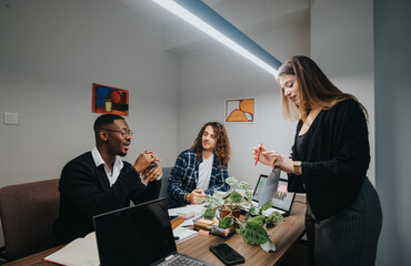 Three coworkers in a modern office setting review business metrics and discuss strategies on a laptop, showcasing teamwork and efficiency.