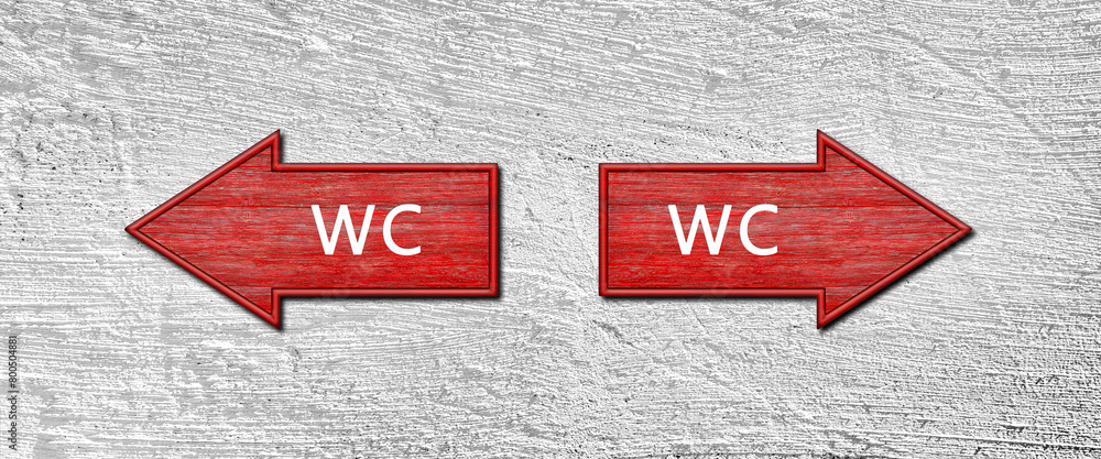 Poster red wooden arrow signs with the word wc hang on a plastered wall. right and left arrow pointers. set
