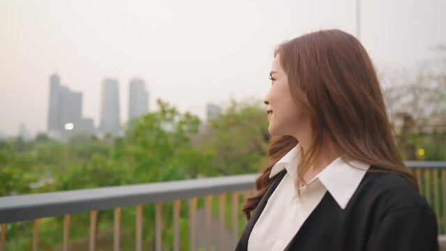 businesswoman walking along the urban walkway inside the park, confident independent urban admiring environment surroundings, job opportunity, good day afterwork lady walking alone, positive attitude 