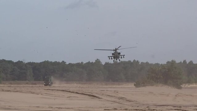 Military Helicopter low altitude hovering with truck
