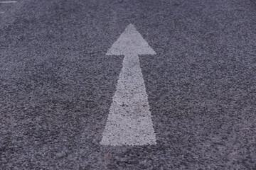 White arrow symbol on the highway
