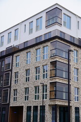 Close up of new modern beige and brown building during the day with no people. Many windows. Tallinn, Estonia, Europe 2024.