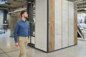 Middle age man choosing ceramic tiles and utensils for his home bathroom