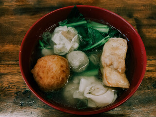 close up of mix meatball on th wooden table. It is contain meatball, green vegetables, tofu,...