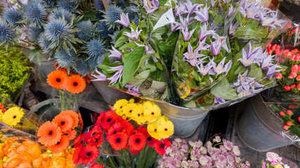 Obraz na płótnie Canvas Variety of fresh colorful flowers at a market, ideal for Mother's Day or International Women's Day bouquets and spring celebrations