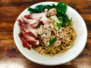 close up of chasiu yamien noodles on the wooden table. It is kind chinese dish with savory taste.