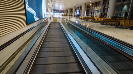 Modern airport interior with empty moving walkway, contemporary design, travel and transportation concept, suitable for topics on business travel or tourism