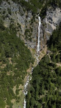 View to the dalfazer Waterfall with forest landscape and the Achensee as a close neighbor