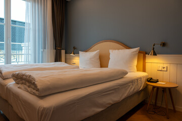 Large double bed bedside tables and lamps in the hotel room. Hotel furniture.