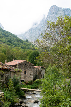 Bulnes with the Tejo River and the mountains in the background. Village located in the Picos de Europa. Asturias - Spain