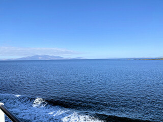 A view of the Isle of Arran in Scotland on a sunny day from the sea