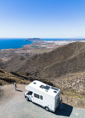 Man by his motor home watching nice views from top of the mountain