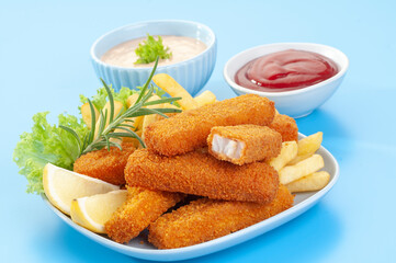 Fried Breaded fish Fingers with salad and condiments 