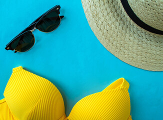 Summer vacation. Swimsuit, sunglasses and a hat on a blue background