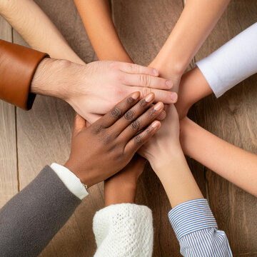 People gather hands for Teamwork - Yelling out a Motivational Shout before taking Action - Different Ethnicity group of People working Together