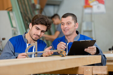 apprentice or trainee beeing tested by craftsman