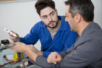 student in electrical engineering course training with teacher