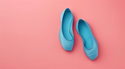 Flat solid color illustration of a pair of cerulean blue ballet slippers on a soft pink background.