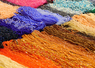 necklaces made of colored glass and strung on nylon thread in the shop selling fashion accessories