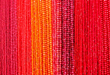 columns with red and orange beads of various shades on sale in the fashion accessories shop