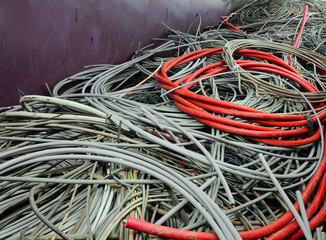 Discarded RED High-Amp Copper Cord Awaits Recycling at Scrap Metal Facility