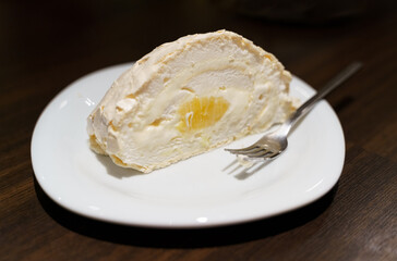 Vanilla Cake Roll Slice on White Plate With Fork