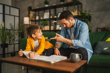 exhausted father help son to finish his homework