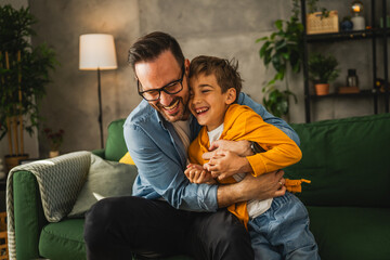 Dad and son tickle and have fun at home