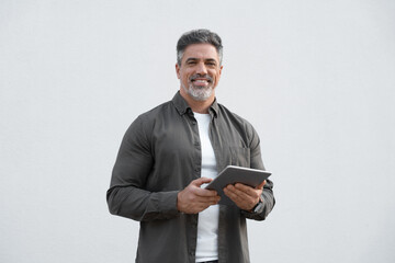 Portrait of Hispanic bearded mature adult professional business man looking at camera. Smiling...