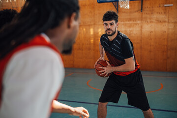 Professional player guarding ball and playing basketball with his diverse team