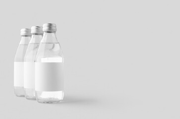 Small water bottle mockup with blank label. Clear glass.